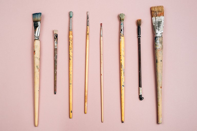 Paint brushes on pink background