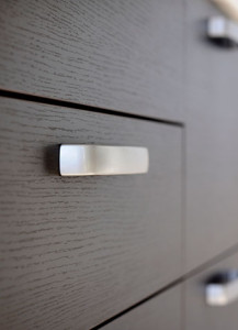 Close up of dark cherry wood dresser drawers