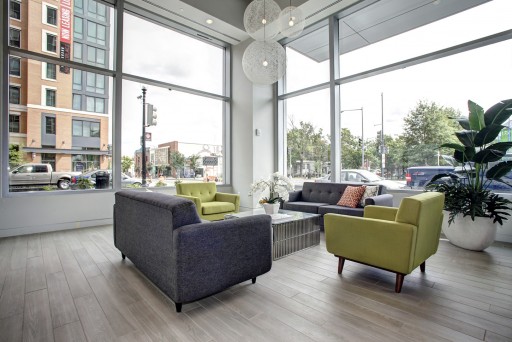 Hodge on 7th resident lounge area with new modern furniture and natural light from windows overlooking street